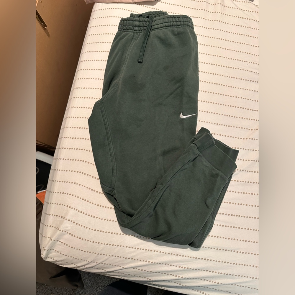 Sage green Nike sweatpants. Some staining below waist band as seen in picture.